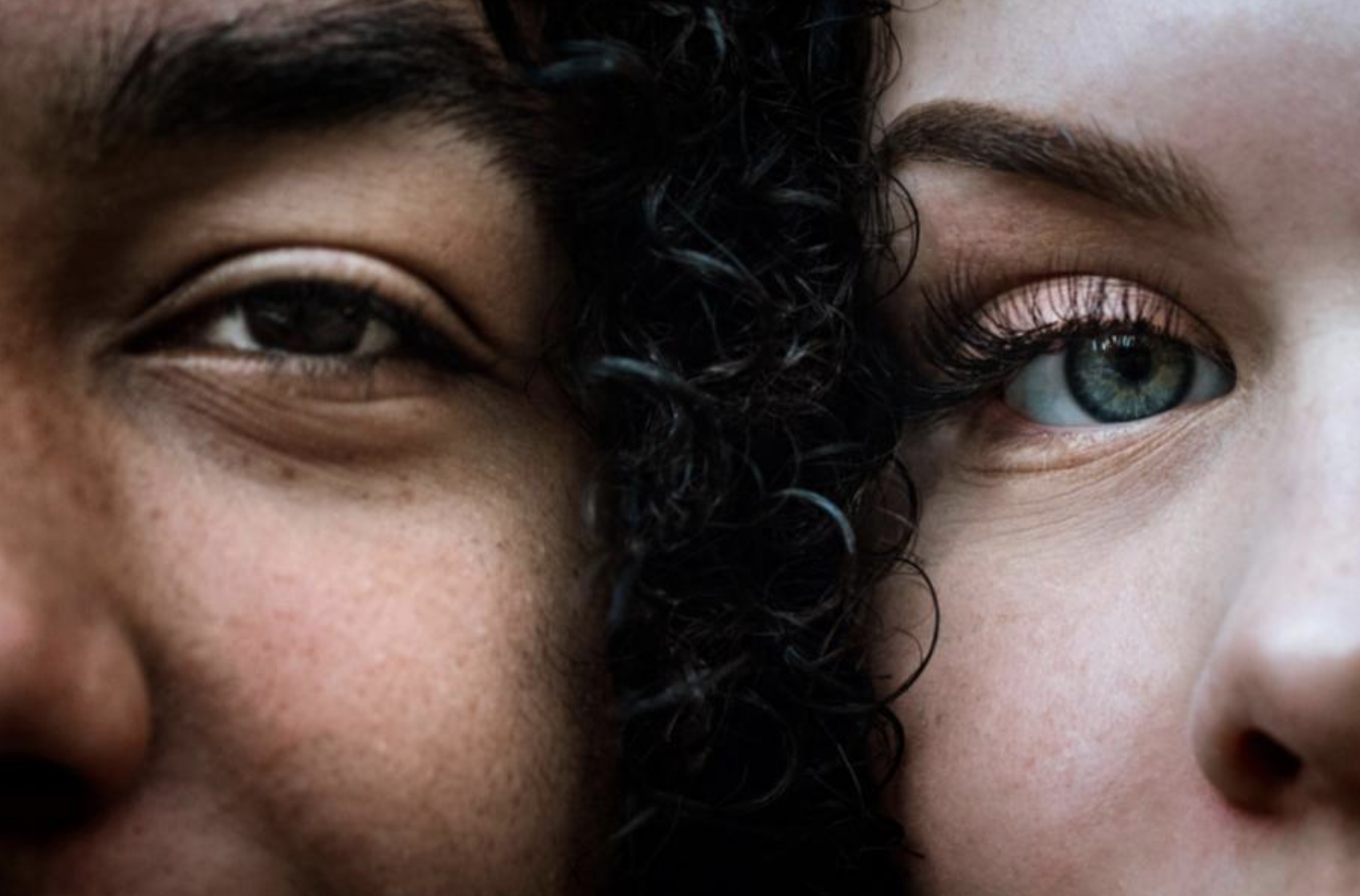 A close up image of the faces of two young people of color